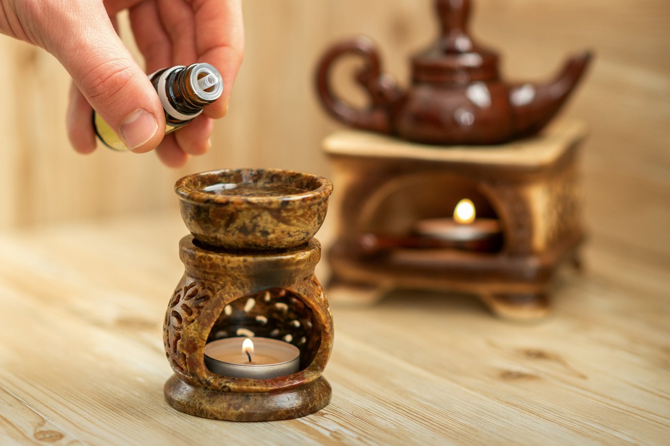 Hand Pours Essential Oil to Diffuser